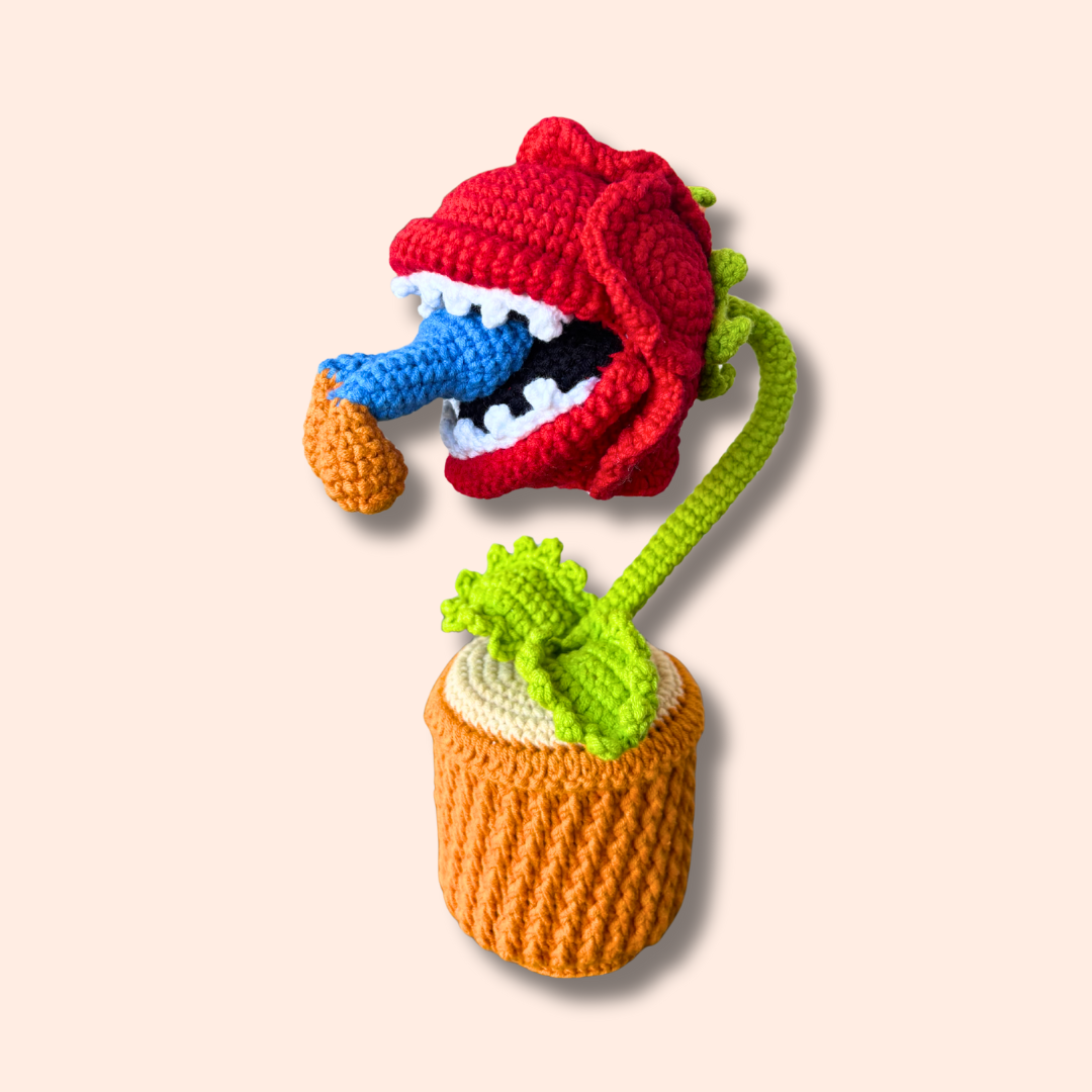 Handmade crocheted Piranha Plant eating Mario